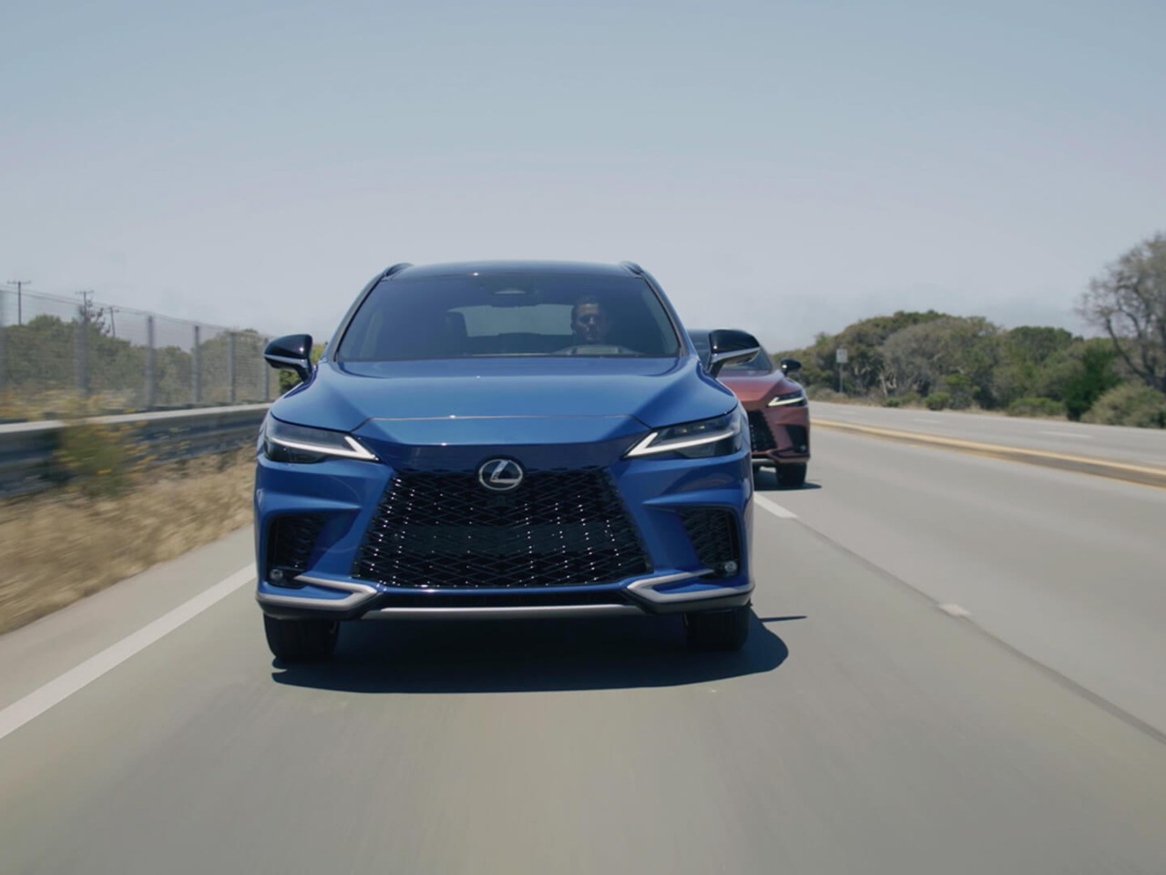 Two Lexux RX's driving on a road