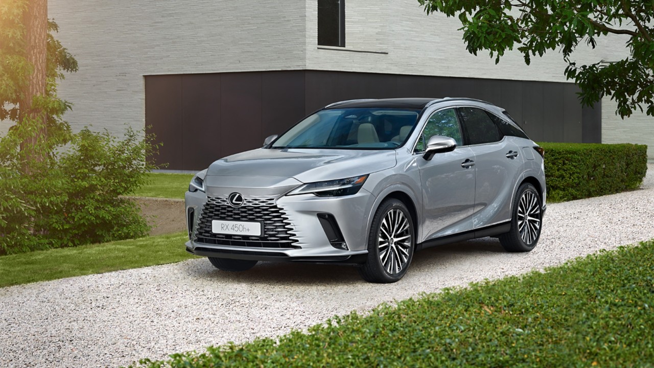 A Lexus RX 450h+ parked in a garage opening