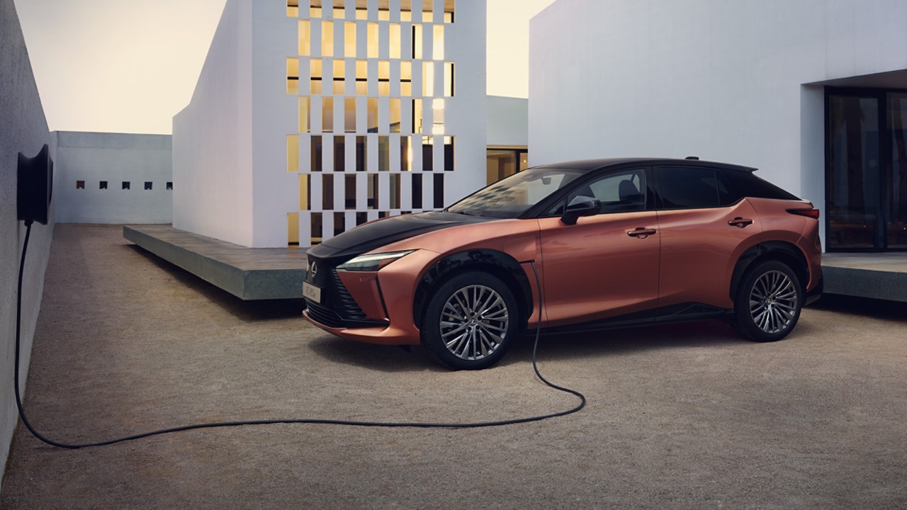 A Lexus RZ 450e plugged into a charging box