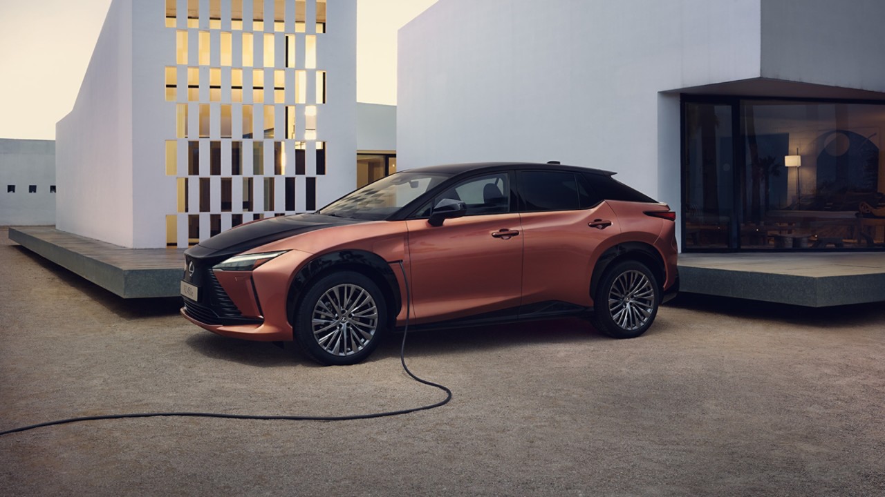 A Lexus RZ 450e plugged into a charging tower