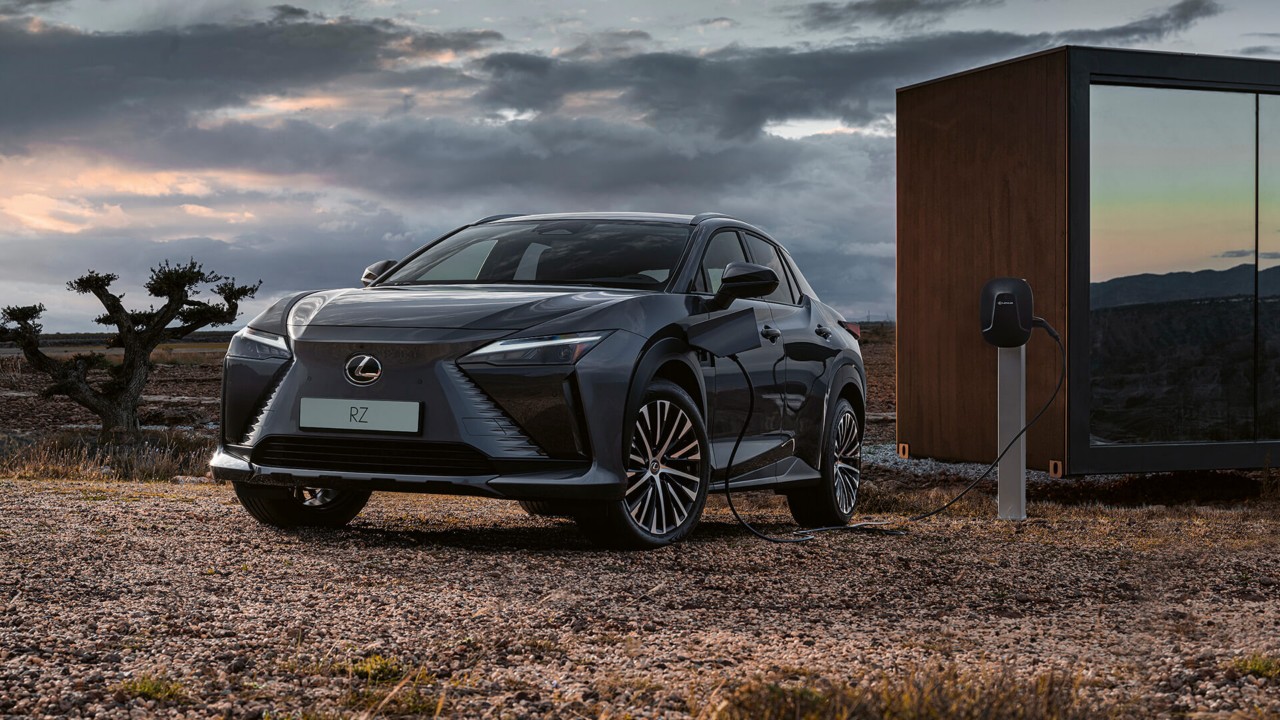 Lexus RZ plugged into a charging tower