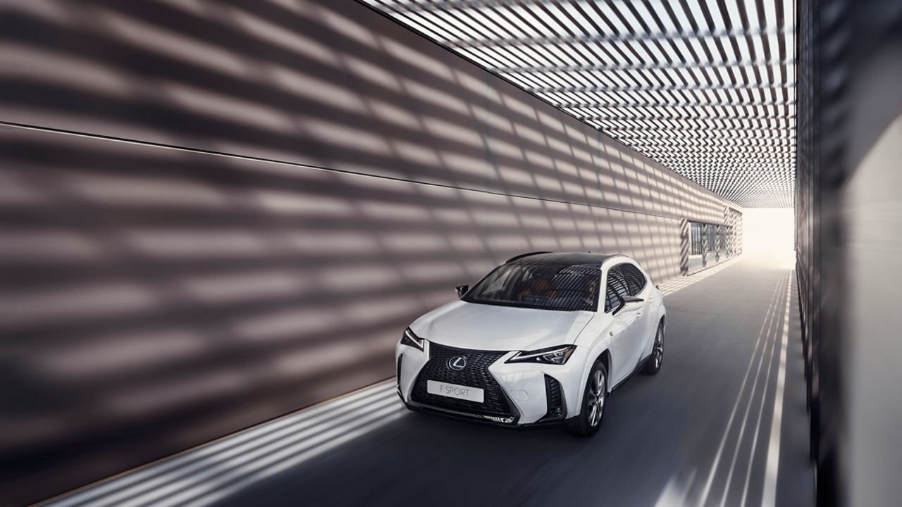  Lexus UX F Sport driving under a structure