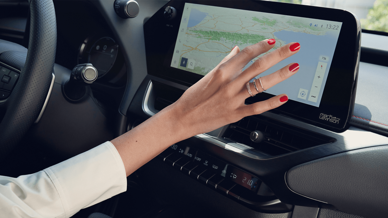 A women interacting with the Lexus UX's navigation system