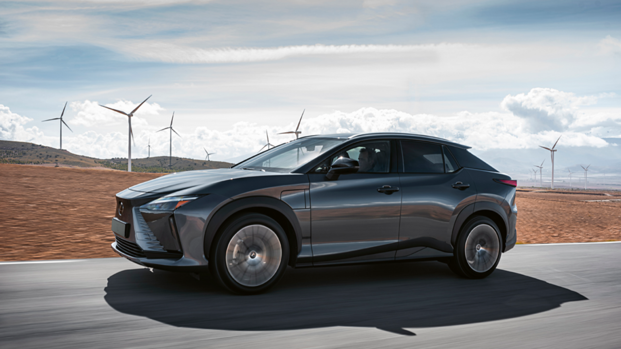 Lexus RZ driving through a wind farm